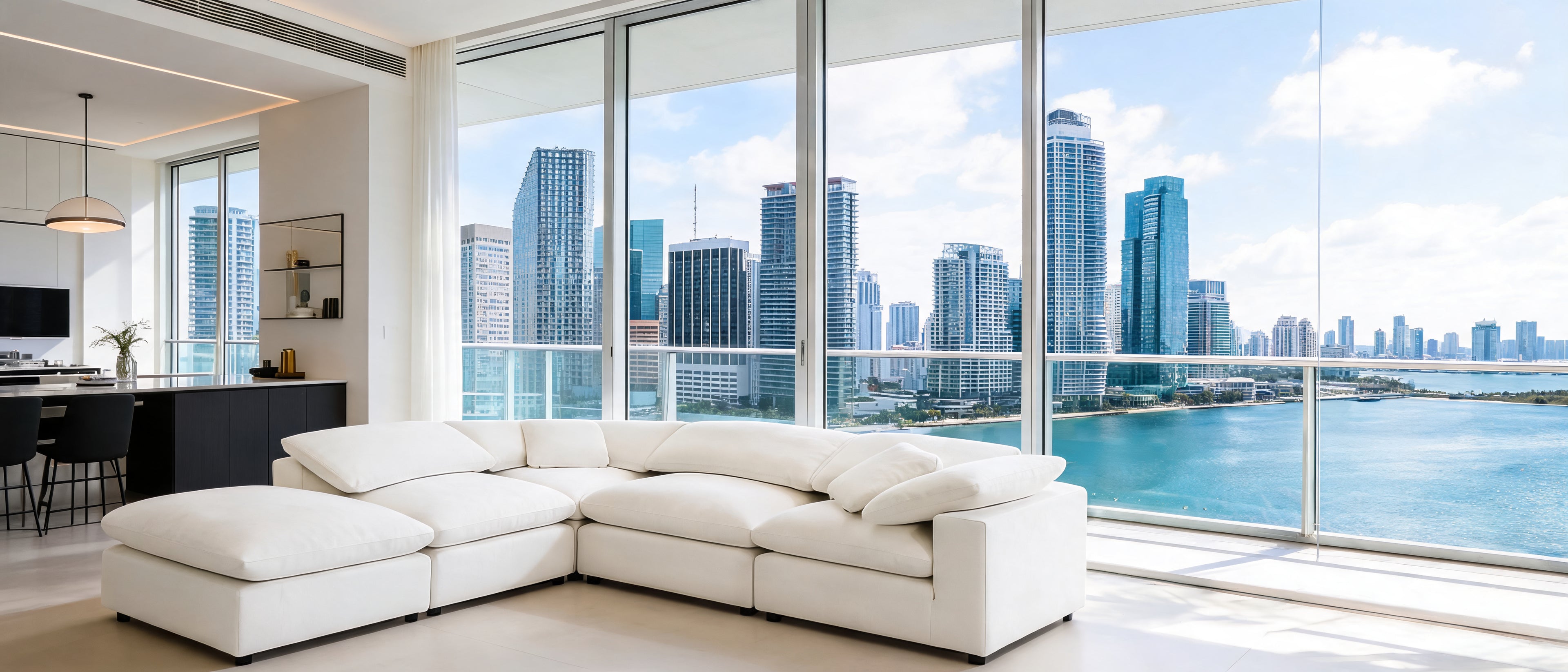 Modern living room with a large sectional sofa and city skyline view.